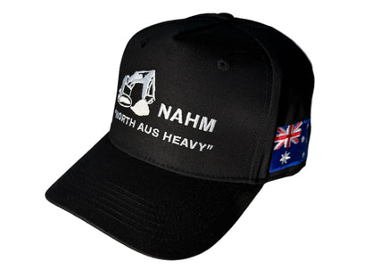 A black trucker-style cap with white embroidered text reading 'NAHM NORTH AUS HEAVY' and a small Australian flag patch on the side.