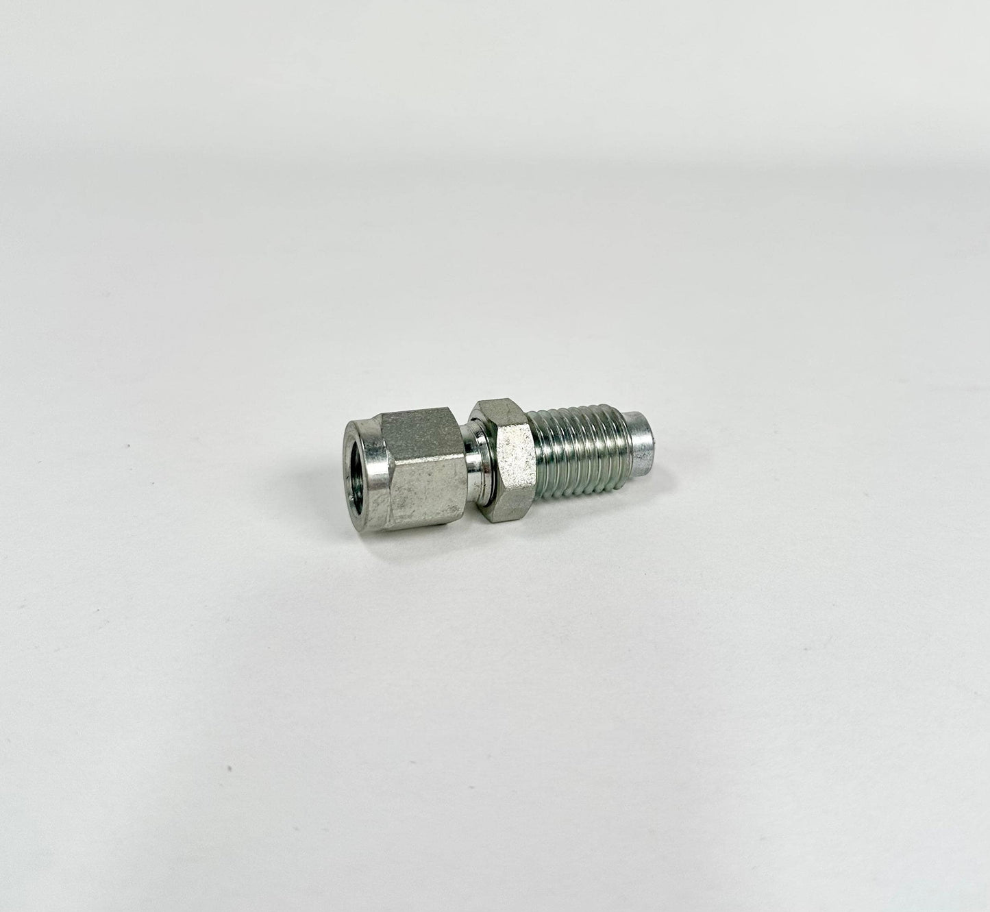 A Cat to Stauff Style adaptor, a small metal hose fitting with a hexagonal nut and threaded body, is displayed on a plain white background.